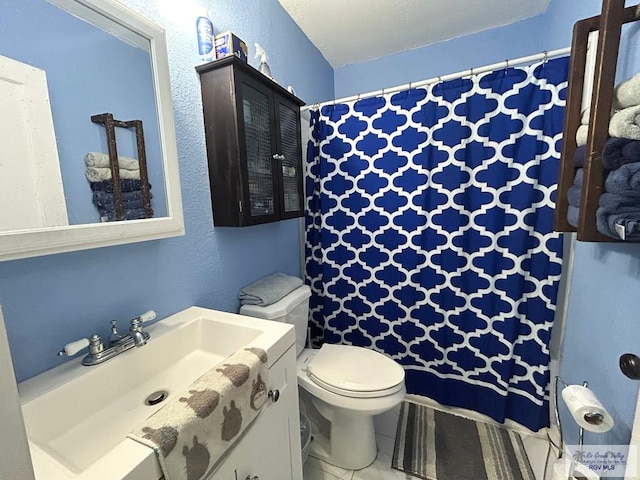 2013 E Jackson St, Harlingen, TX 78550 - bathroom featuring toilet, vanity, and a shower with shower curtain