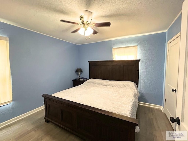 2013 E Jackson St, Harlingen, TX 78550 - bedroom featuring wood finished floors, ornamental molding, a textured ceiling, baseboards, and a ceiling fan