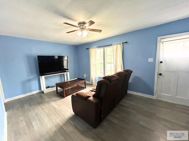 2013 E Jackson St, Harlingen, TX 78550 - living area with wood finished floors, ceiling fan, and baseboards