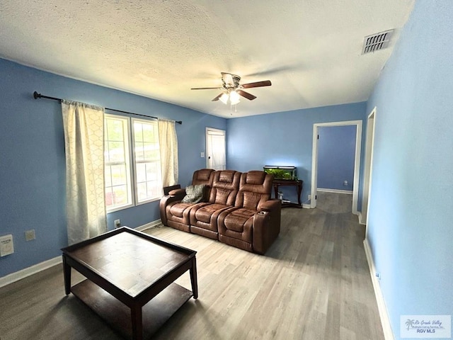 2013 E Jackson St, Harlingen, TX 78550 - living area with a ceiling fan, baseboards, and wood finished floors