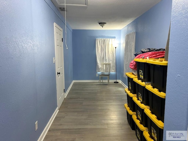 2013 E Jackson St, Harlingen, TX 78550 - hall with wood finished floors, baseboards, and attic access