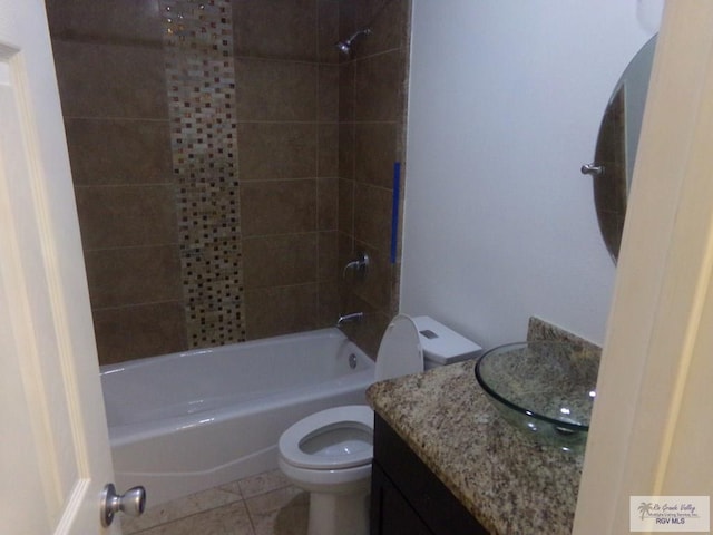 full bathroom featuring tile patterned flooring, vanity, toilet, and tiled shower / bath combo