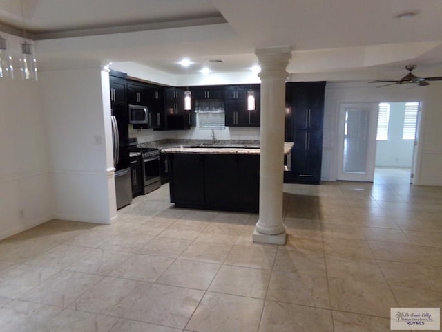 kitchen featuring appliances with stainless steel finishes, decorative columns, and ceiling fan