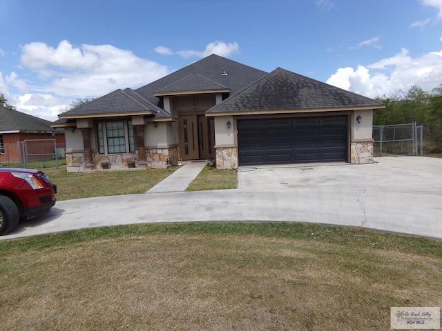 view of front of home with a front yard and a garage