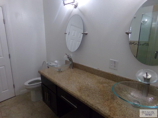 bathroom featuring tile patterned floors, vanity, and toilet