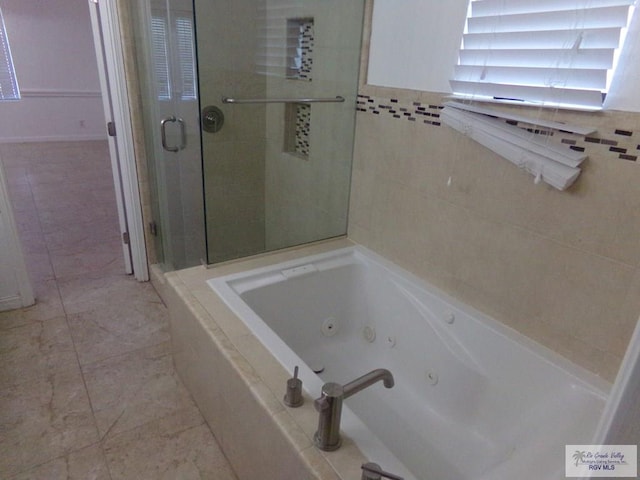 bathroom with separate shower and tub and tile patterned flooring