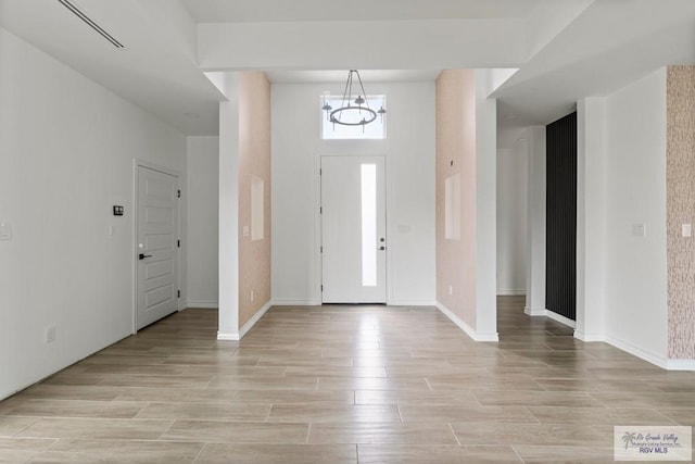 6221 King Palm Loop, Brownsville, TX 78526 - foyer with a chandelier, light wood-style flooring, and baseboards