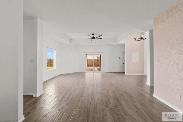 6221 King Palm Loop, Brownsville, TX 78526 - unfurnished living room with plenty of natural light, wood finished floors, and a chandelier