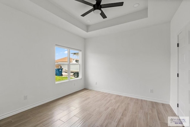 6221 King Palm Loop, Brownsville, TX 78526 - spare room featuring wood finished floors, a ceiling fan, baseboards, and a tray ceiling