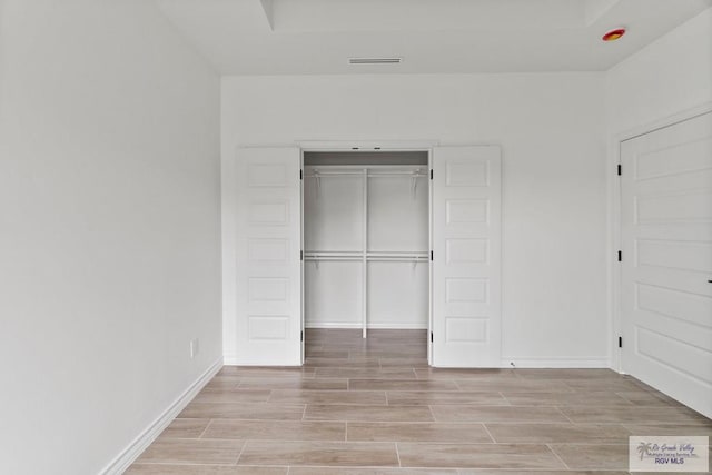 6221 King Palm Loop, Brownsville, TX 78526 - unfurnished bedroom featuring wood tiled floors, a closet, and baseboards