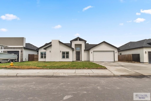 6221 King Palm Loop, Brownsville, TX 78526 - view of front of house featuring stucco siding, concrete driveway, and a garage