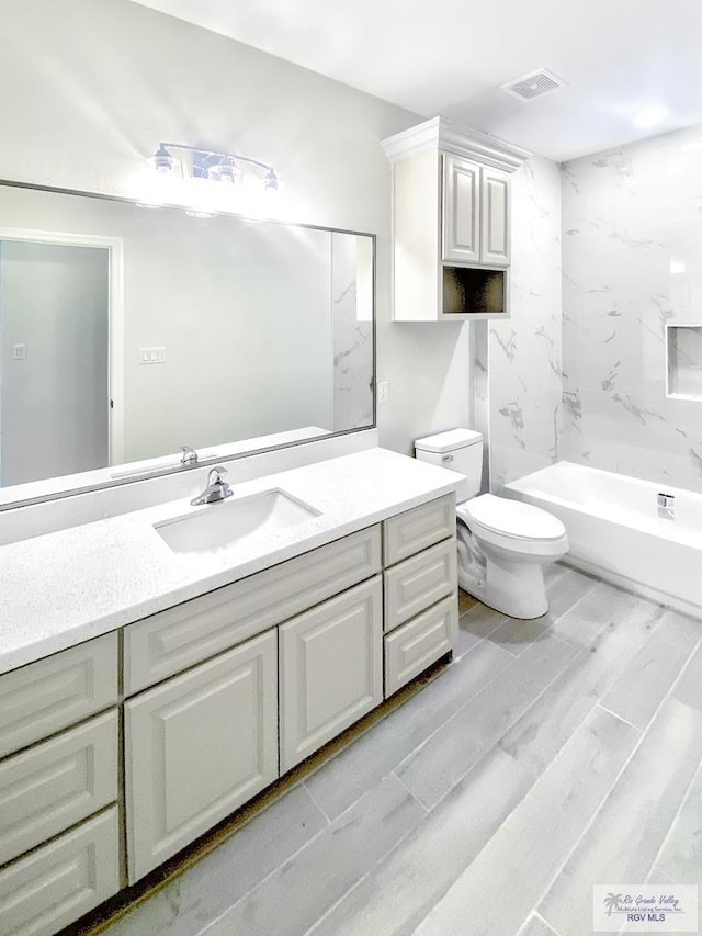 full bath featuring shower / bath combination, visible vents, toilet, wood finished floors, and vanity