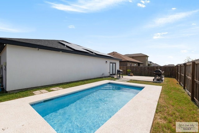 view of swimming pool featuring a patio area and a grill