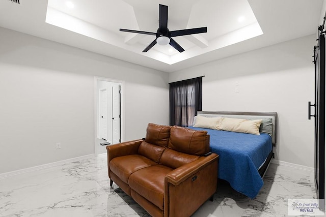 bedroom featuring a tray ceiling and ceiling fan