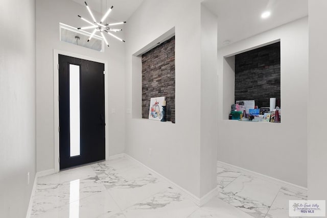 foyer with a chandelier