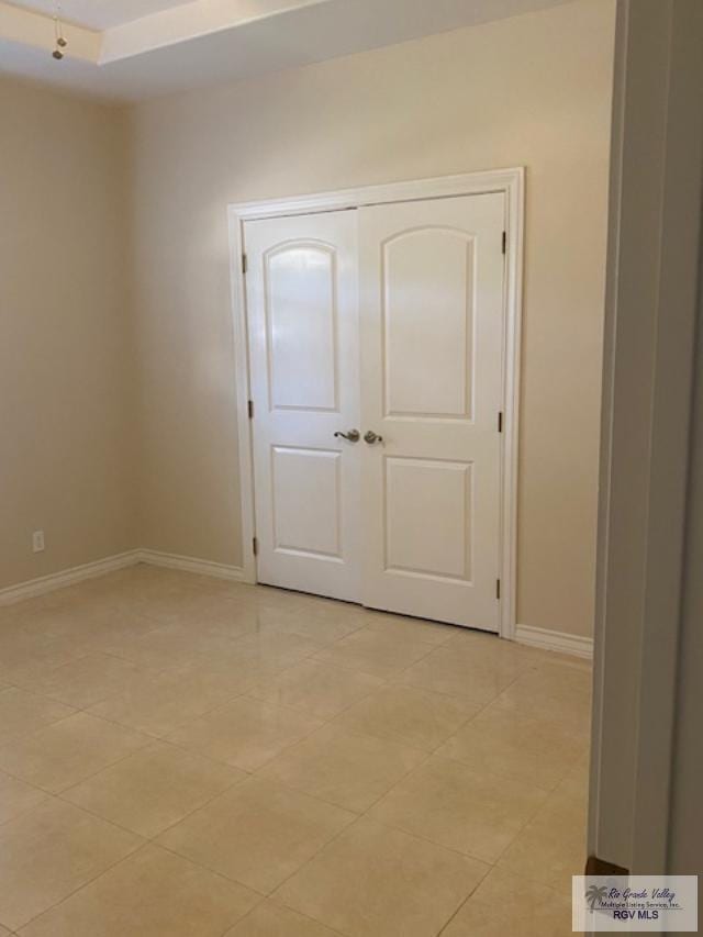 unfurnished bedroom with light tile patterned floors