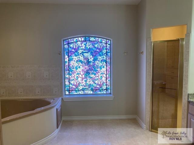 bathroom featuring vanity, tile patterned floors, and separate shower and tub