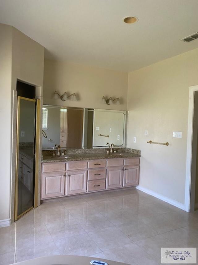 bathroom with vanity and a shower with door