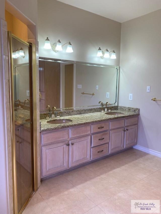 bathroom with vanity and a shower with door