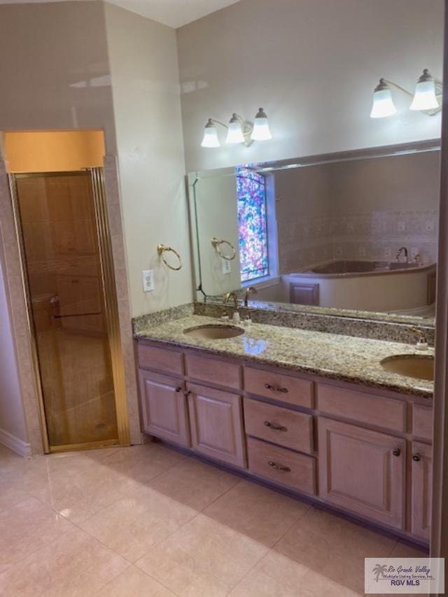 bathroom featuring tile patterned flooring, vanity, and a bathtub