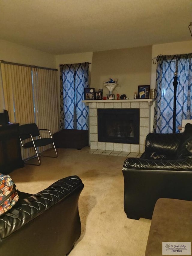 living room featuring carpet flooring and a tile fireplace