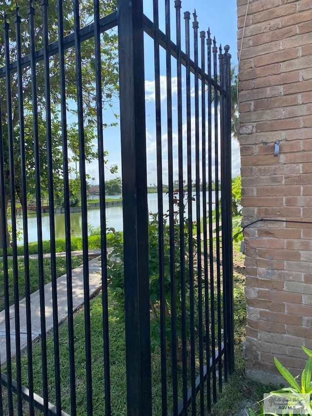 view of gate with a water view