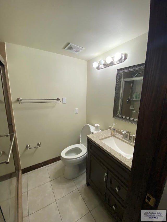 bathroom featuring tile patterned floors, vanity, and toilet