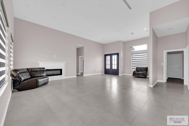 unfurnished living room featuring french doors