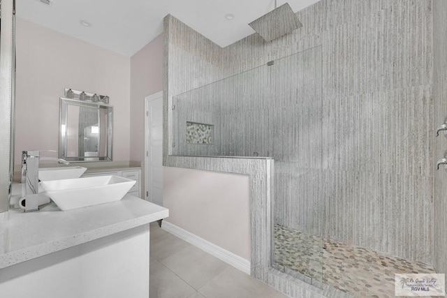 bathroom with tile patterned floors, vanity, and a shower