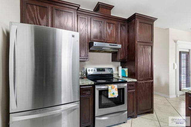 kitchen featuring dark brown cabinets, light stone countertops, stainless steel appliances, and light tile patterned floors