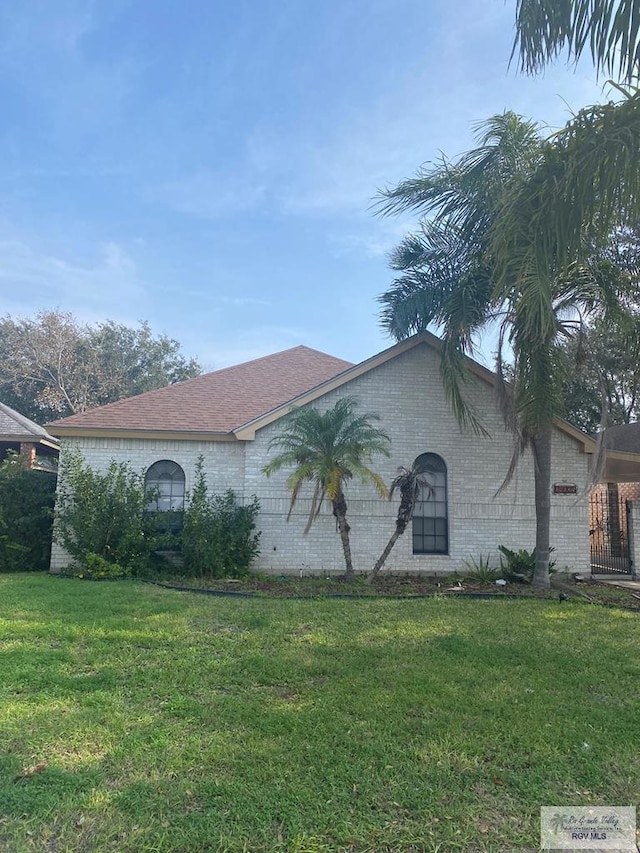 view of side of property with a lawn