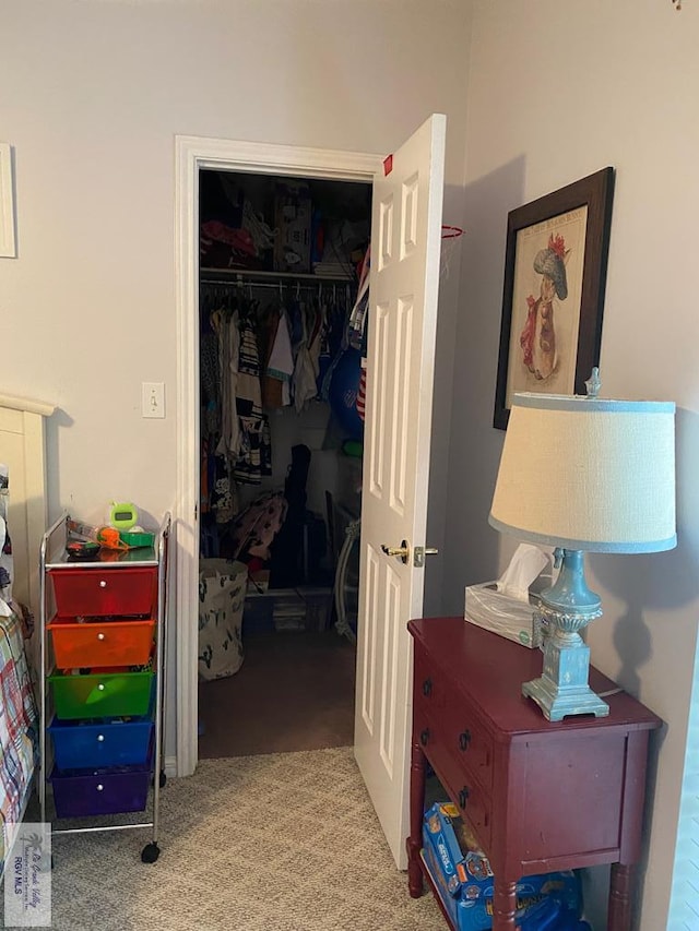 bedroom featuring light carpet and a closet