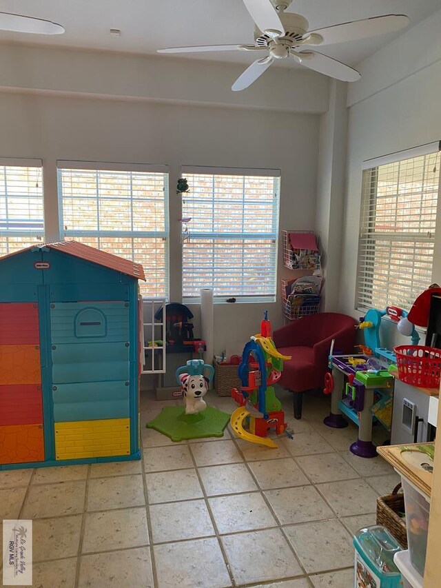 playroom with tile patterned flooring and ceiling fan