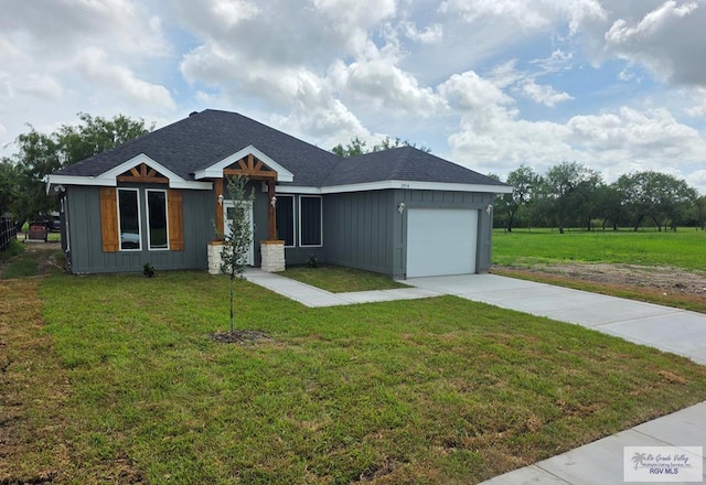 2914 Brushy Ct, Harlingen, TX 78552 - single story home with board and batten siding, driveway, an attached garage, a front lawn, and roof with shingles
