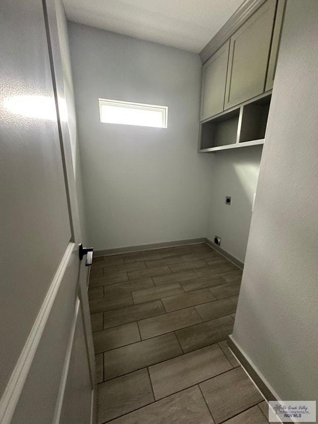 2914 Brushy Ct, Harlingen, TX 78552 - laundry room with hookup for an electric dryer and cabinet space