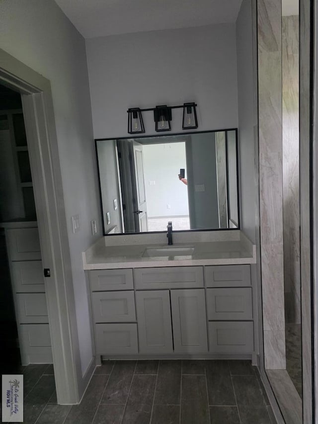 2914 Brushy Ct, Harlingen, TX 78552 - bathroom featuring vanity, tile patterned floors, and a shower