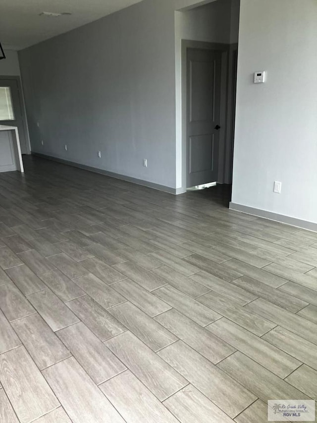 2914 Brushy Ct, Harlingen, TX 78552 - unfurnished living room with wood finish floors and baseboards