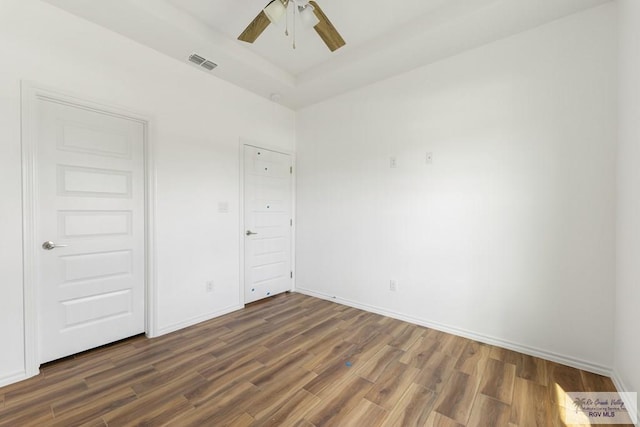 unfurnished bedroom with dark hardwood / wood-style floors and ceiling fan