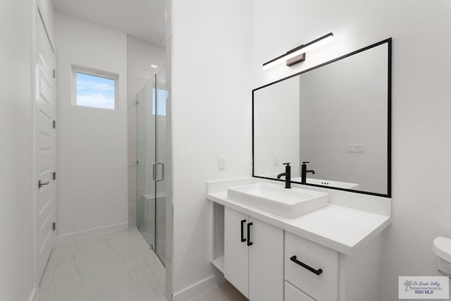 bathroom with vanity, toilet, and walk in shower