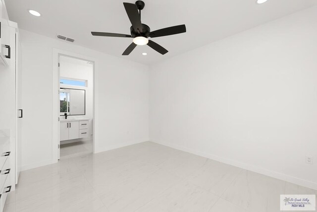 spare room featuring ceiling fan and sink