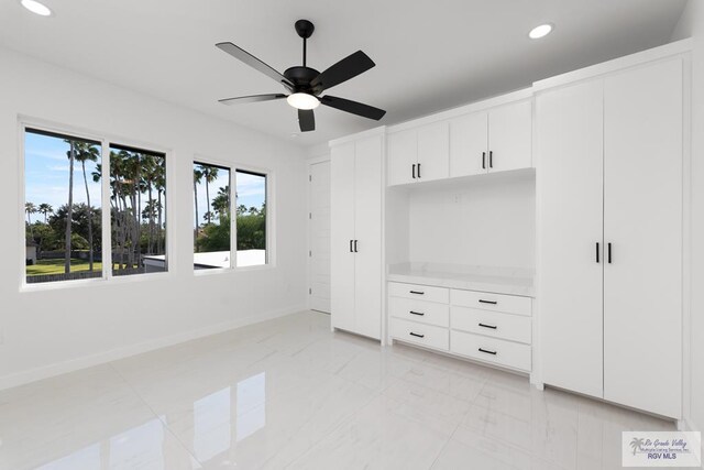 unfurnished bedroom featuring ceiling fan