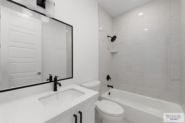 full bathroom featuring vanity, toilet, and tiled shower / bath