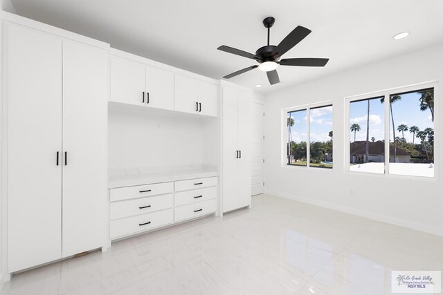 unfurnished bedroom featuring ceiling fan