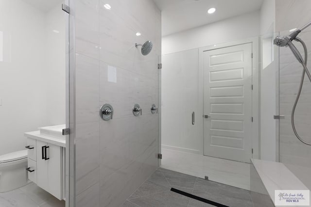 bathroom with vanity, toilet, and walk in shower