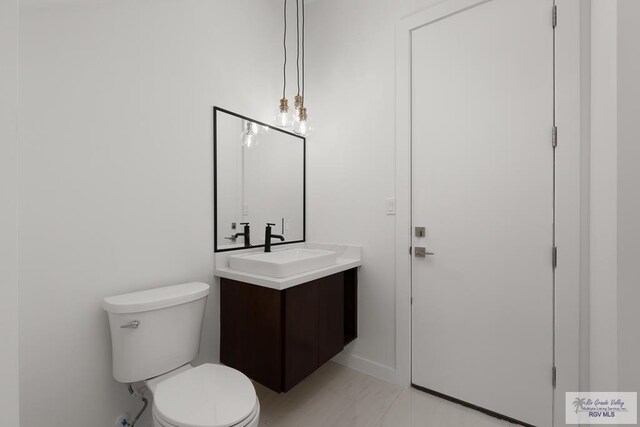 bathroom featuring vanity and toilet