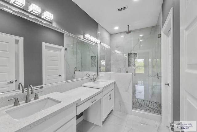 bathroom with a shower with shower door and vanity