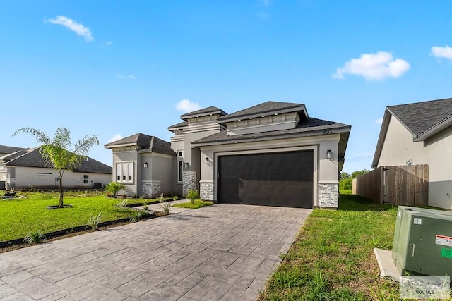 view of front of property featuring a front lawn and a garage