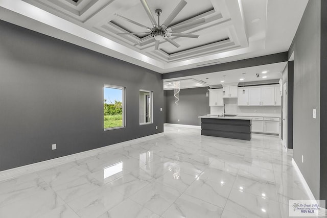 unfurnished living room with ceiling fan and sink