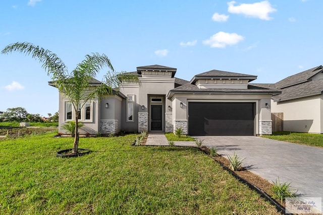 prairie-style home featuring a front lawn and a garage