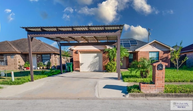 view of front of home featuring a carport, solar panels, a garage, and a front lawn